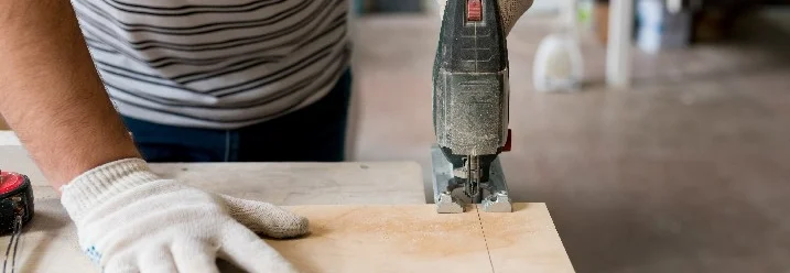 Person sägt Holz mit Stichsäge